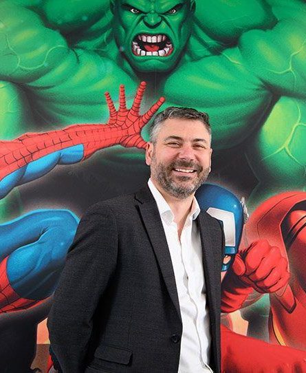 Merlin Entertainments CTO Lee Cowie in front of Marvel backdrop discusses Oracle Hospitality strategy.