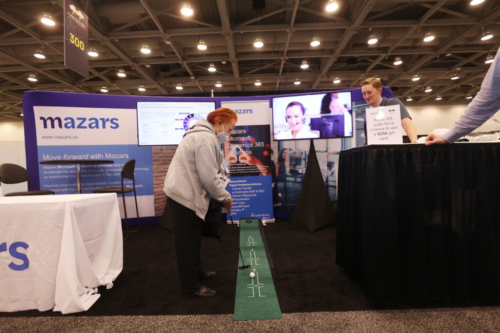 Mazars keeps attendees entertained with a putting green in their expo both.