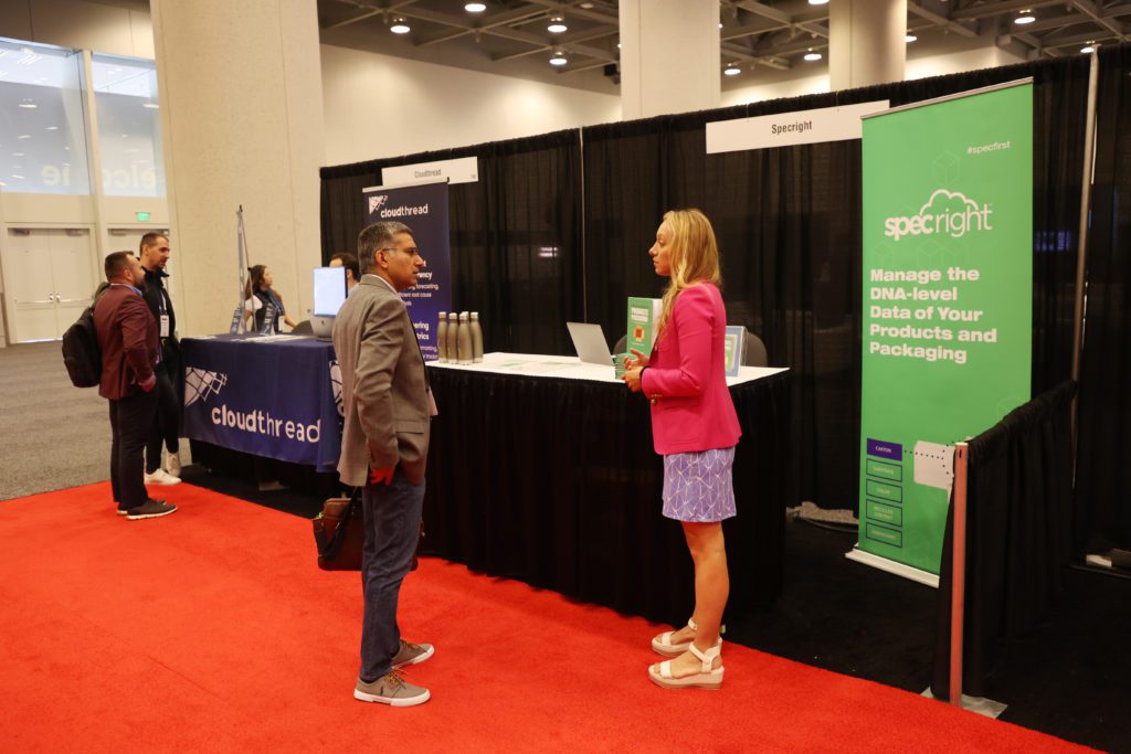 Startups Cloudthread (left) and Specright (right) ready their expo booths before doors open to conference attendees Thursday afternoon.