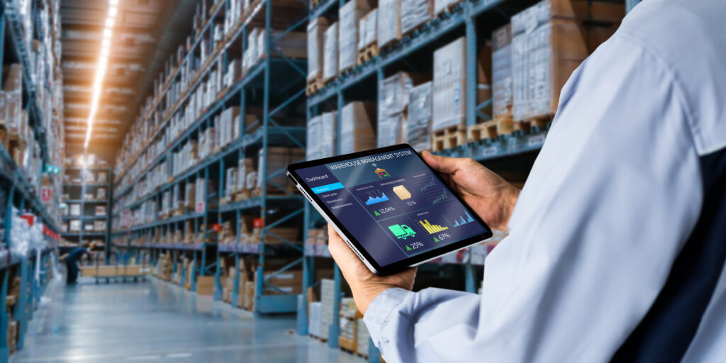 Person in a warehouse holding a tablet